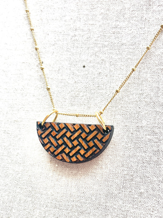 Chunky cherry wood etched and stained pendant necklace with 24 inch gold plated brass satellite chain.